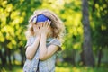 Happy child girl playing on colorful spring field. Blooming dandelions on background, outdoor seasonal activities. Royalty Free Stock Photo