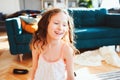 Happy child girl playing at home in cozy weekend morning Royalty Free Stock Photo