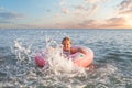 Happy child girl playing in the sea. Kid having fun outdoors. Summer vacation and healthy lifestyle concept Royalty Free Stock Photo