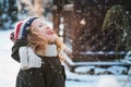 Happy child girl playing with snow on snowy winter walk on backyard Royalty Free Stock Photo