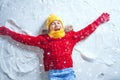 Kid making snow angel. Royalty Free Stock Photo