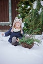 Happy child girl plays in winter snowy garden Royalty Free Stock Photo