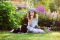 happy child girl relaxing in summer garden with her spaniel dog Royalty Free Stock Photo