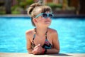 Happy child girl relaxing on swimming pool side on sunny summer day Royalty Free Stock Photo