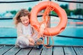 Happy child girl with rescue ring with sea background, safety on the water concept Royalty Free Stock Photo