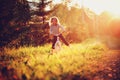 Happy child girl riding bicycle in summer sunset on country road Royalty Free Stock Photo