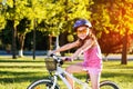 Happy child girl riding bicycle in summer sunset Royalty Free Stock Photo