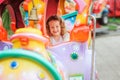 Happy child girl riding train on funfair on summer vacation Royalty Free Stock Photo