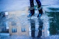 Happy child girl running and jumping in puddles after rain. Childhood, laisure, happiness concept Royalty Free Stock Photo