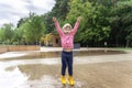 happy child girl running and jumping in puddles after rain in summer Royalty Free Stock Photo