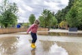 happy child girl running and jumping in puddles after rain Royalty Free Stock Photo