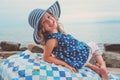 Happy child girl at sea, cozy summer holidays on seaside
