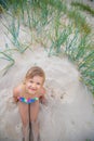 Happy child girl sitting on the beach