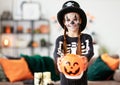 Happy child girl in skeleton costume to halloween