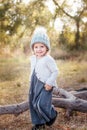 Happy child girl smilling and playing in autumn outdoors