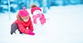 Happy child girl with a snowman on a winter walk Royalty Free Stock Photo