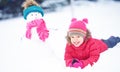 Happy child girl with a snowman on a winter walk Royalty Free Stock Photo