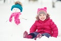 Happy child girl with a snowman on a winter walk Royalty Free Stock Photo
