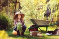 Happy child girl with spaniel dog playing little farmer in autumn garden Royalty Free Stock Photo