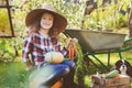 Happy child girl with spaniel dog playing little farmer in autumn garden Royalty Free Stock Photo