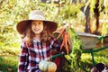 Happy child girl with spaniel dog playing little farmer in autumn garden Royalty Free Stock Photo