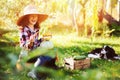 Happy child girl with spaniel dog playing little farmer in autumn garden Royalty Free Stock Photo