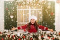 Happy child girl stretches her hand to catch falling snowflakes. Royalty Free Stock Photo