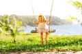 Happy child girl swinging on swing at beach in summer Royalty Free Stock Photo