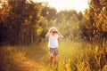 Happy child girl watching birds with binoculars in summer