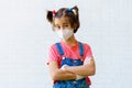 Child girl wearing a protection mask against coronavirus during Covid-19 pandemic Royalty Free Stock Photo