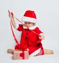 Happy child girl wearing Santa hat opening Christmas gift box Royalty Free Stock Photo