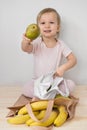 Happy child gives fruits from eco reusable textile bag