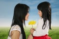 Happy child giving flower to her mother Royalty Free Stock Photo