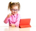 Happy child in glasses looking at ipad mini tablet pc screen