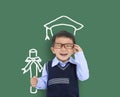 Happy child in graduation cap and holding the diploma against chalkboard Royalty Free Stock Photo