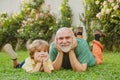Happy child with Grandfather playing outdoors. Grandfather with Son and Grandson having Fun in Park. Happy grandfather Royalty Free Stock Photo