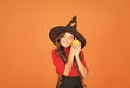 Happy child on Halloween wear witch carnival costume indoor holding pumpkin, jack o lantern Royalty Free Stock Photo