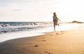 Happy child having fun running on the beach at sunset - Adorable little girl playing along the sea water Royalty Free Stock Photo