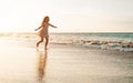 Happy child having fun running on the beach at sunset - Adorable little girl playing along the sea water Royalty Free Stock Photo