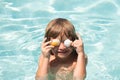 Happy child having fun at swimming pool on summer day. Children playing in blue sea water. Funny kids face. Covered eyes Royalty Free Stock Photo