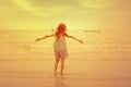 Happy child having fun walk on the beach at sunset. Adorable little girl playing along the seawater. Childhood and freedom summer Royalty Free Stock Photo