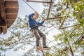 Happy child in a helmet, healthy teenager school boy enjoying activity in a climbing adventure park on a summer day Royalty Free Stock Photo