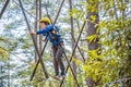 Happy child in a helmet, healthy teenager school boy enjoying activity in a climbing adventure park on a summer day Royalty Free Stock Photo