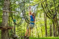 Happy child in a helmet, healthy teenager school boy enjoying activity in a climbing adventure park on a summer day Royalty Free Stock Photo
