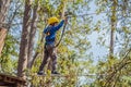 Happy child in a helmet, healthy teenager school boy enjoying activity in a climbing adventure park on a summer day Royalty Free Stock Photo