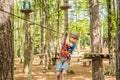 Happy child in a helmet, healthy teenager school boy enjoying activity in a climbing adventure park on a summer day Royalty Free Stock Photo