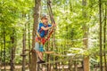 Happy child in a helmet, healthy teenager school boy enjoying activity in a climbing adventure park on a summer day Royalty Free Stock Photo