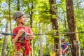 Happy child in a helmet, healthy teenager school boy enjoying activity in a climbing adventure park on a summer day Royalty Free Stock Photo