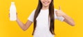 happy child hold dairy beverage product. teen girl going to drink milk. healthy lifestyle.