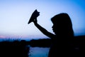 Happy child holding flightnumber silhouette on nature in the park sunset